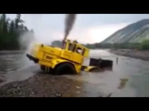 A Russian tractor driver refuses to give up after his vehicle gets stuck in a river.